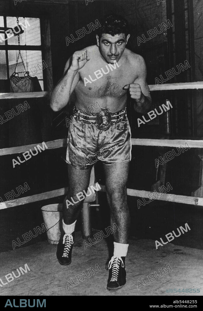 "Jack In The Gym" - New Champion Wears His Lonsdale Belt -- This latest picture of Jack Gardner shows him wearing his Lonsdale Belt, coveted trophy of British boxing. Busy training in Jack Solomon's Windmill street gymnasium, London, is British and European Heavyweight champion, ex Guardsman Jack Gardner. Gardner's forthcoming fight with Argentine ex-policeman Cesar Brion has been tentatively fixed for May 22nd at Harringay. April 06, 1951. (Photo by Fox Photos).