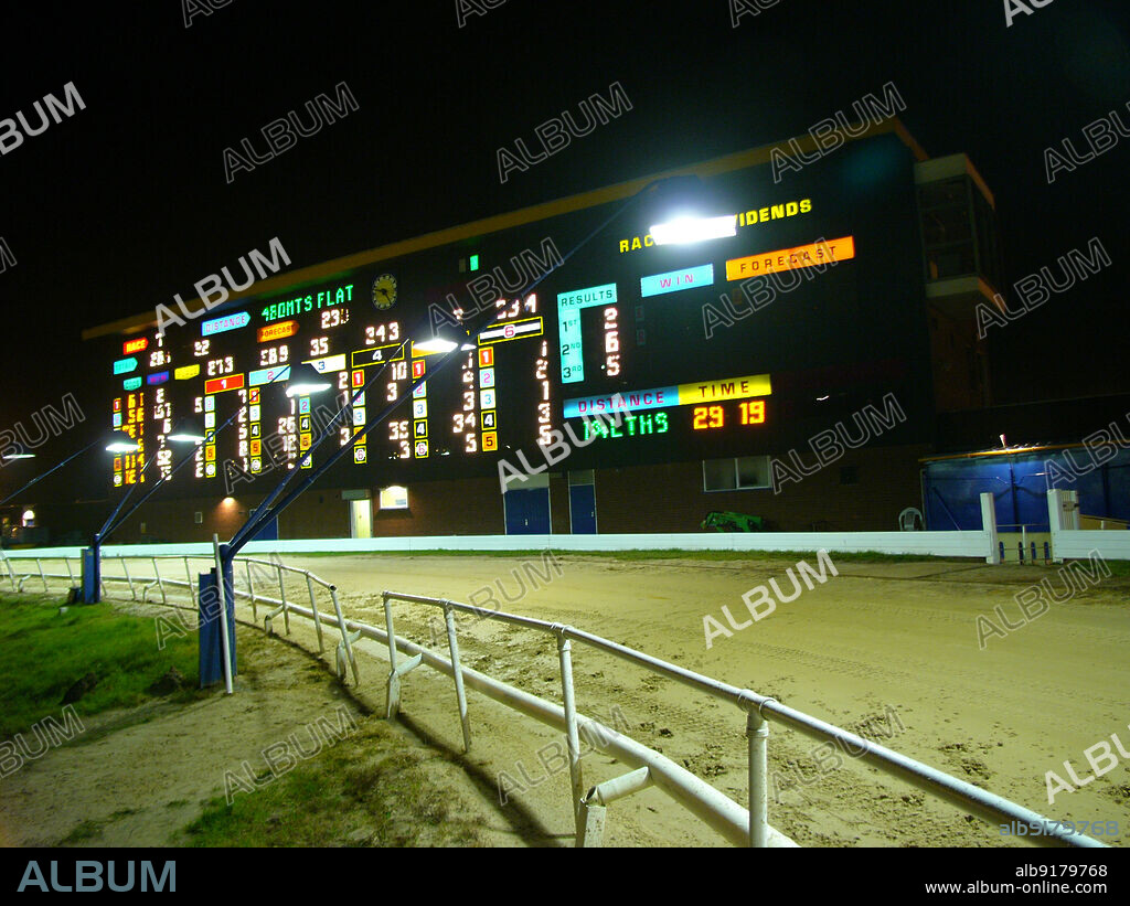 SIMON INGLIS. Hall Green Greyhound Stadium, York Road, Hall Green, Birmingham, 2005. The illuminated scoreboard at Hall Green Greyhound Stadium, illuminated during a race night. Hall Green Greyhound Stadium was opened in 1927 despite opposition from local residents. The stadium later also included a speedway track (closed 1937) and football pitch (1951-1965). Investment and development during the late 20th century saw Hall Green win the Greyhound Racing Association Racecourse of the Year award in 2002. The stadium closed in 2017 and was demolished in 2018; the site was subsequently redeveloped as housing.