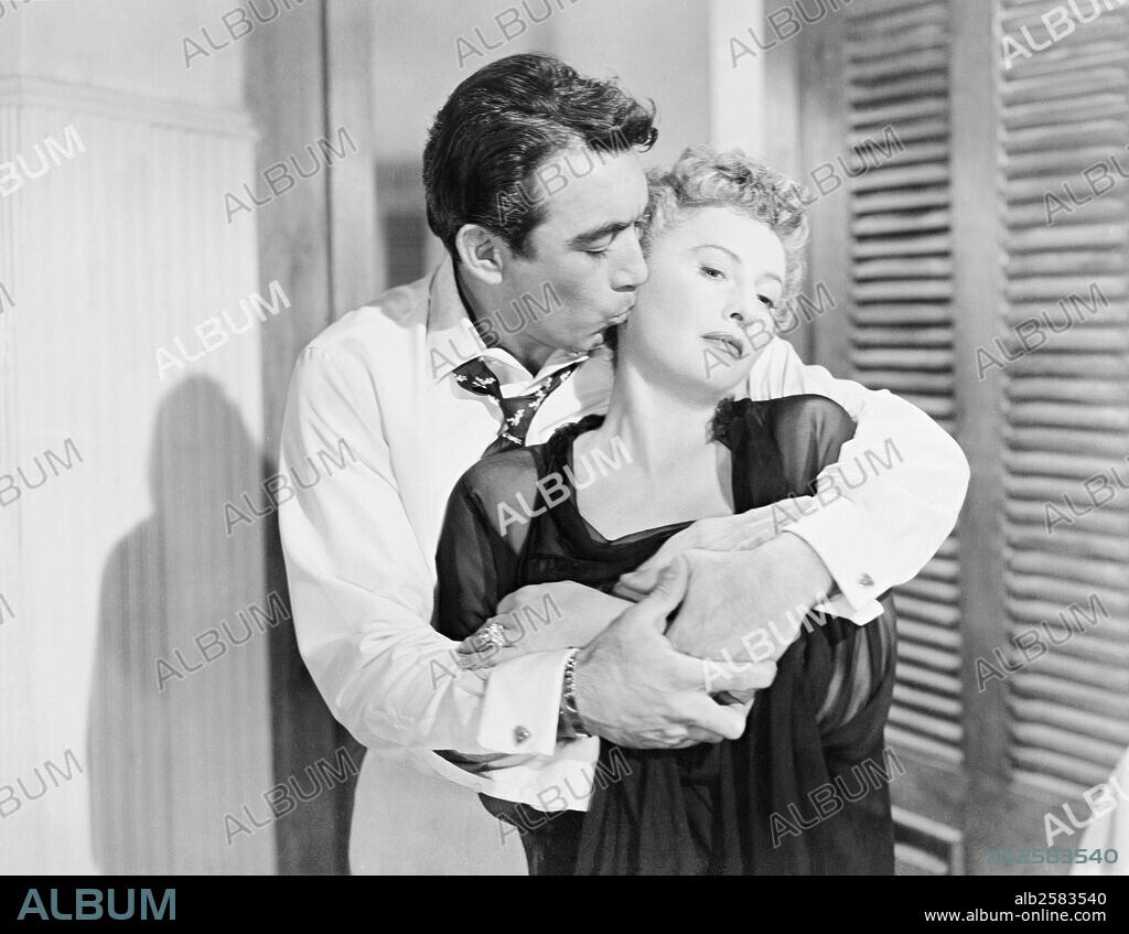 ANTHONY QUINN and BARBARA STANWYCK in BLOWING WILD, 1953, directed by HUGO FREGONESE. Copyright WARNER BROTHERS.