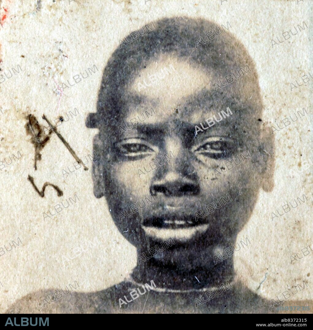 This photograph of a 'Liberated African' slave was taken after they were freed from slaving ships by the British Navy. From 1861 to 1874, more than 2500 'Liberated Africans' were shipped to Port Victoria, Seychelles.<br/><br/>. While the Slave Trade continued across eastern and southern Africa and the Indian Ocean, the 'liberated' were taken to a depot, classified by the District Magistrate, photographed, renamed, and assigned as 'apprentices' to the French-owned plantations, where they were indentured for five years.