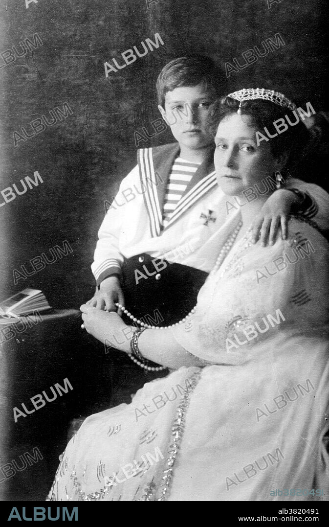 Alexandra Feodorovna Romanova (1872-1918), Empress consort of Russia and spouse of Nicholas II, with her son Alexei Nikolaevich, Tsarevich of Russia (1904-1918). Alix of Hesse and by Rhine (June 6, 1872 - July 17, 1918), was Empress consort of Russia as spouse of Nicholas II, the last Emperor of the Russian Empire. Born a granddaughter of Queen Victoria of the United Kingdom, she was given the name Alexandra Feodorovna upon being received into the Russian Orthodox Church. Alexandra is best remembered as the last Tsarina of Russia. Alexei (August 12, 1904 - July 17, 1918), the young heir, was afflicted with hemophilia B, a hereditary disease that prevents blood from clotting properly, which at that time was untreatable and usually led to an untimely death. As a granddaughter of Queen Victoria, Alexandra carried the same gene mutation that afflicted several of the major European royal houses, such as Prussia and Spain. Hemophilia therefore became known as "the royal disease". Alexandra had passed it on to her son.