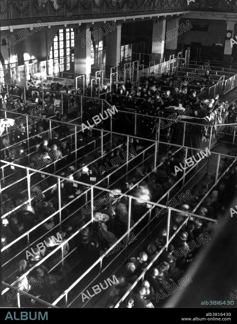 Entitled: "Emigrants in pens at Ellis Island, New York, probably on or near Christmas, note the decorations, 1906." The Federal Government assumed control of immigration in 1890 and Congress appropriated $75,000 to construct America's first Federal immigration station on Ellis Island. The present main structure was designed in French Renaissance Revival style and built of red brick with limestone trim. When it opened on December 17, 1900, officials estimated 5,000 immigrants per day would be processed. By the time it closed on November 12, 1954, 12 million immigrants had been processed by the U.S. Bureau of Immigration. Today, over 100 million Americans, one third of the population, can trace their ancestry to the immigrants who first arrived in America at Ellis Island before dispersing to points all over the country. Underwood & Underwood, 1906.