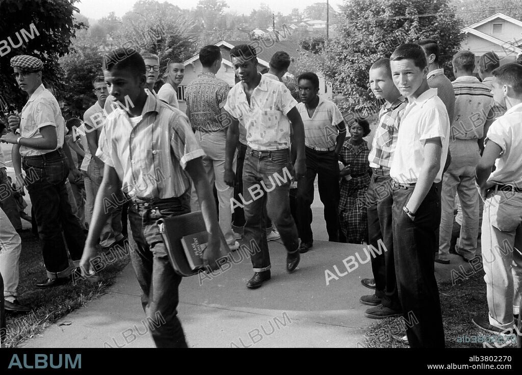 Entitled: "Clinton, Tennessee. School integration conflicts" shows a line of African-American boys walking through a crowd of white boys during a period of violence related to school integration. Desegregation is the process of ending the separation of two groups usually referring to races. This is most commonly used in reference to the United States. Desegregation was long a focus of the American Civil Rights Movement, both before and after the United States Supreme Court's decision in Brown v. Board of Education, particularly desegregation of the school systems and the military. Racial integration, or simply integration, includes desegregation (the process of ending systematic racial segregation). In addition to desegregation, integration includes goals such as leveling barriers to association, creating equal opportunity regardless of race, and the development of a culture that draws on diverse traditions, rather than merely bringing a racial minority into the majority culture. Desegregation is largely a legal matter, integration largely a social one. Although widespread, this distinction between integration and desegregation is not universally accepted. Photographed by Thomas J. O'Halloran December 4, 1956.