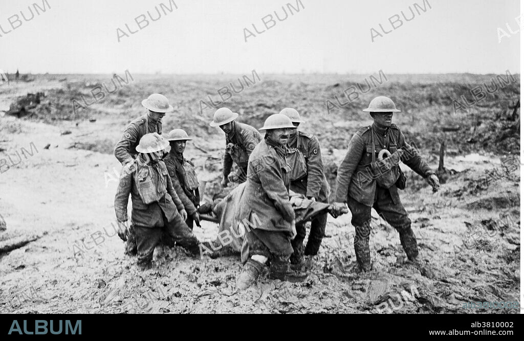 It took a stretcher party of seven to carry a wounded soldier from the muddy battlefield, August 1917. The Battle of Pilckem Ridge, July 31 - August 2, 1917, was the opening attack of the main part of the Battle of Passchendaele in WWI. The Allied attack had mixed results. A substantial amount of ground was captured and a large number of casualties inflicted on the German defenders, but the German defenders also recaptured some ground on the XIX Corps front, from the Ypres-Roulers railway, north to St. Julien. Heavy rainfall had a serious effect on operations, causing more problems for the British who were advancing into the area devastated by artillery fire and was mostly flooded and muddy. The Battle of Passchendaele took place on the Western Front, between July and November 1917, for control of the ridges south and east of the Belgian city of Ypres in West Flanders. Passchendaele lay on the last ridge east of Ypres, five miles from a railway junction at Roeselare, which was a vital part of the supply system of the German Fourth Army. The resistance of the German Fourth Army, unusually wet weather, the onset of winter and the diversion of British and French resources to Italy, allowed the Germans to avoid a general withdrawal. The campaign ended in November when the Canadian Corps captured Passchendaele. In his memoirs (1938) Lloyd George, British Prime Minister during WWI, wrote, 'Passchendaele was indeed one of the greatest disasters of the war ... No soldier of any intelligence now defends this senseless campaign ...'.