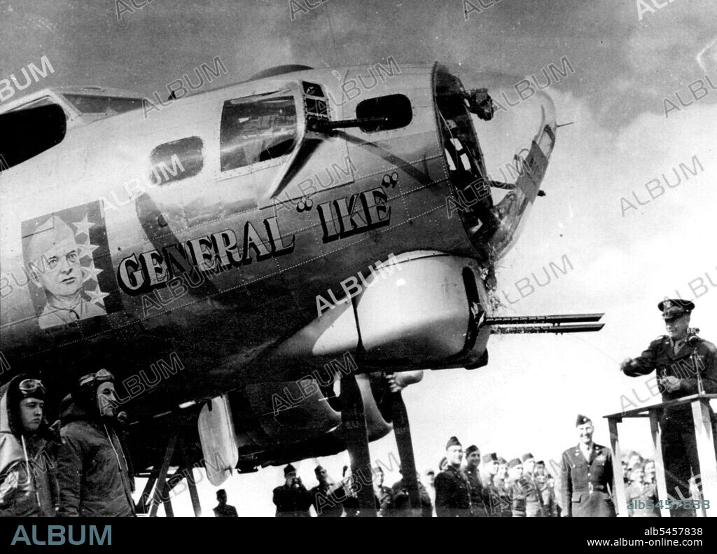 Gen. Eisenhower Names The "General 'Ike'"Gen. Dwight D. Eisenhower (right) christens the flying fortress "General ' Ike'" at a U.S. heavy bomber station in England by smashing a bottle of Mississippi river water against the baffels of the ship's. 50 caliber guns. April 18, 1944. (Photo by Associated Press Photo).