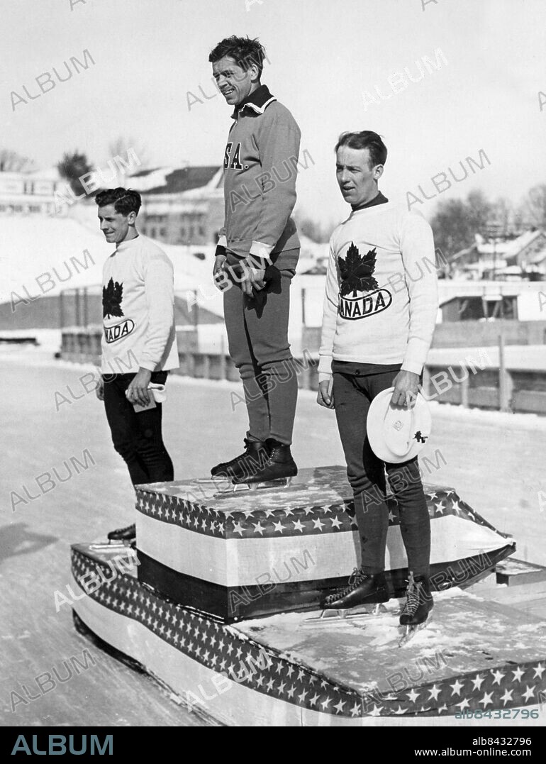 Orig. bildtext... JACK SHEA WINS SECOND TITLE IN OLYMPICS. Jack Shea, 21-year-old son of a Lake Placid butcher, again thrilled the home town folk when he skated to a brilliant victory in the 1,500 race in the winter Olympics at lake Placid, N.Y. today. Second and third places went to Alex Hurd and William Logan of Canada, respectively. Above, left to right, after the race, are Hurd, Shea and Logan. 2/5/1932 Not. William Logan Anm. John Amos Shea, mer känd som Jack Shea, 1910-2002, amerikansk skridskoåkare, vann två guldmedaljer vid vinter-OS 1932. Alexander Hurd, 1910-1982, kanadensisk skridskoåkare, vann en silvermedalj och en bronsmedalj vid vinter-OS 1932. William Willy Logan, 1907-1955, kanadensisk skridskoåkare, vann två bronsmedaljer vid vinter-OS 1932. Vinter-OS OS i Lake Placid 1932 Skridskor Symboler Emblem Lönnlöv Trio Vinnare Segrare Idrottsmän Nivåskillnad CD556 persons: WILLIAM LOGAN;ALEXANDER HURD;JACK SHEA sites: CANADA*;LAKE PLACID;USA.