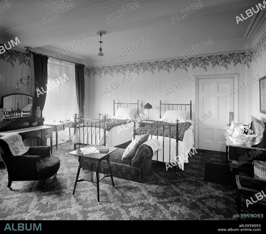 Grosvenor Hotel, 101 Buckingham Palace Road, London, 1910. Bedroom 146 in the Grosvenor Hotel, London. The hotel was built to serve Victoria Station by JT Knowles in 1861, and was extended in 1907. The comforts of this bedroom included a washstand, but also more modern electric lighting.