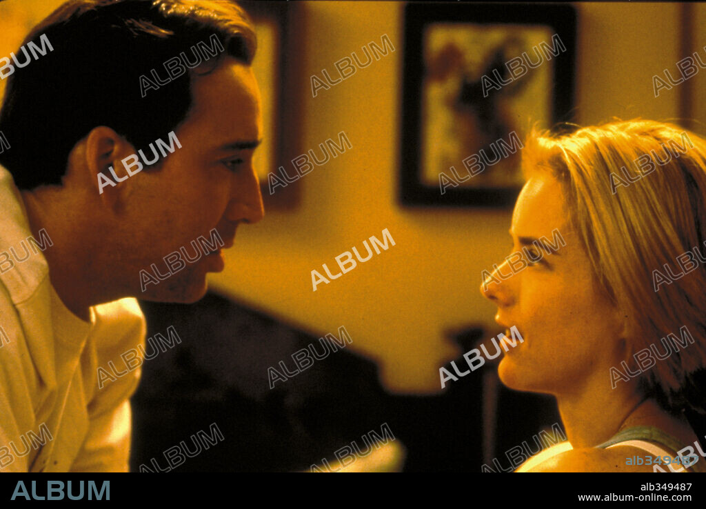 NICOLAS CAGE and TEA LEONI in THE FAMILY MAN, 2000, directed by BRETT RATNER. Copyright BEACON COMMUNICATIONS LLC / MORTON, MERRICK.