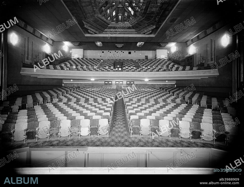 Auditorium at the Odeon, Great North Road, Barnet, London, c1935. Viewed frorm the stage looking towards the back doors. Designed in the Art Deco style with an octagonal ceiling feature, and a carpet with a fan motif. This was a design used in many Odeon cinemas of the time. It was designed by George Simmons.