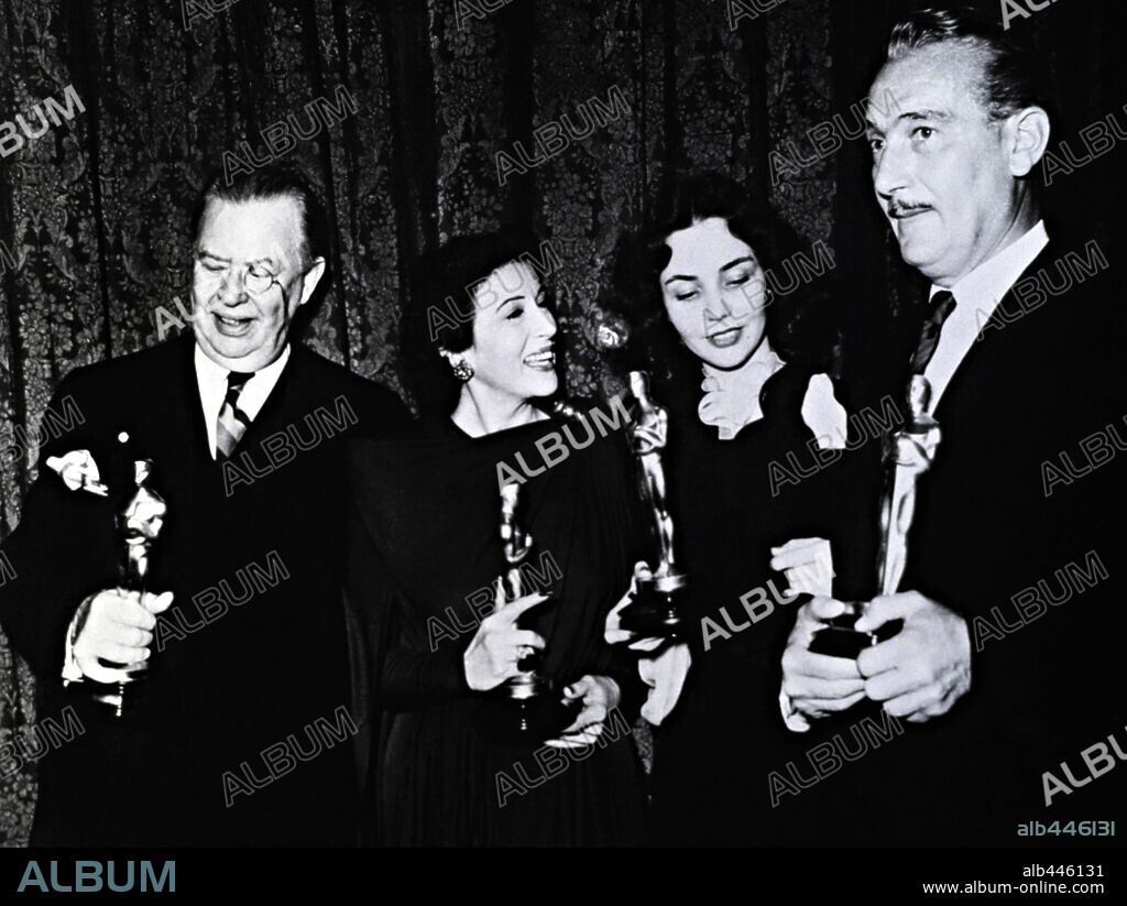 CHARLES COBURN, JENNIFER JONES, KATINA PAXINOU and PAUL LUKAS. The 16th Academy Awards / 1944. 
Paul Lukas, best actor for "Watch on the Rhine". Jennifer Jones, best actress for "The Song of Bernadette". Katina Paxinou, best actress in a supporting role for "For Whom the Bells Tolls". Charles Coburn, best actor in a supporting role for  "The More the Merrier". 1944