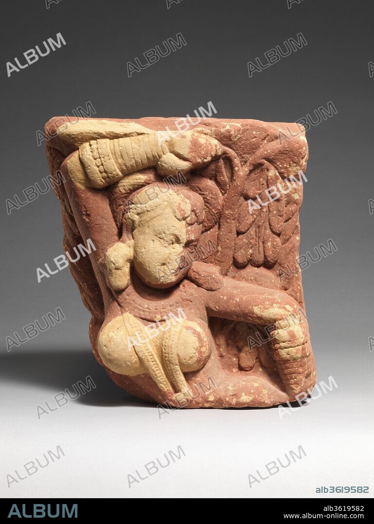 Tree Spirit Deity (Yakshi). Culture: India (Uttar Pradesh, Mathura region). Dimensions: H. 13 3/4 in. (34.9 cm); W. 12 1/2 in. (31.8 cm); D. 5 in. (12.7 cm). Date: 1st-2nd century.
This double-sided bracket (vrksadevata) for a gateway (torana) is decorated on either side with a tree-spirit deity known as a yakshi, who holds a flowering tree as a symbol of her fecundity. Her pose is that of salabhanjika ("breaking a branch of the sala tree"): grasping a branch, she thus engages with the fertility of the earth, bringing the tree into flower. Such figures provided an auspicious presence at the entrance to a sacred site.