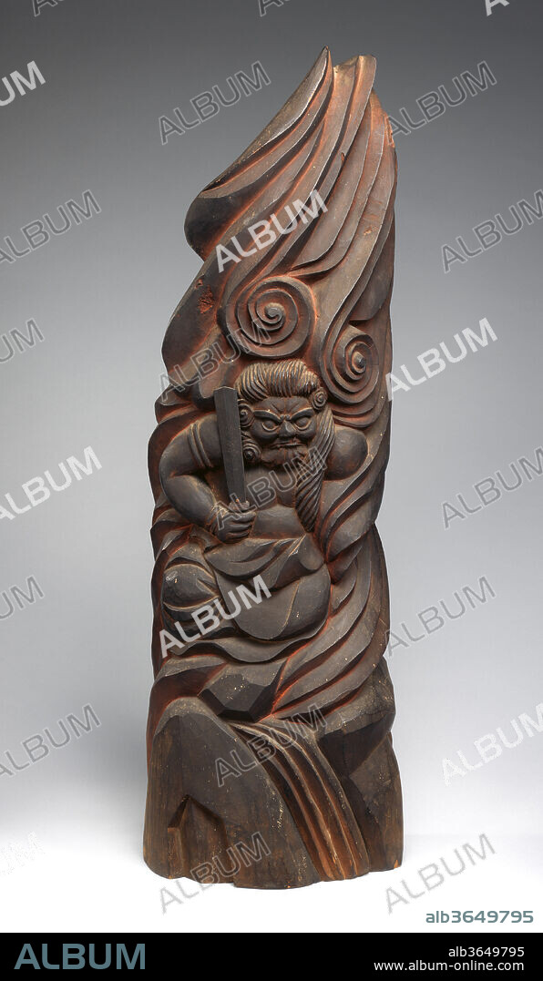 Fudo Myoo. Artist: Mokujiki Shonin (Japanese, 1718-1810). Culture: Japan. Dimensions: H. 35 7/16 in. (90 cm); W. 14 9/16 in. (37 cm); D. 9 13/16 in. (25 cm). Date: 1805.
Statues of the Buddhist protective deity Fudo Myoo, the "immovable wisdom king," are a familiar sight at temples in Japan. In contrast to meticulously carved works by professionals, this type of roughly hewn sculpture is the creation of an amateur monk-sculptor. Mokujiki was motivated by religious enthusiasm to make thousands of sculptures of Buddhist deities and popular gods of good fortune. 
Mokujiki's sculptures were rediscovered in the early twentieth century by art critic Yanagi Soetsu (1889-1961), an advocate of the virtues of mingei, literally, "people's art." Yanagi admired the direct, unaffected power of Mokujiki's sculpture asrepresenting the ideal of an indigenous, popular Japanese art. While his technique is referred to as natabori--"hatchet-carved"--Mokujiki actually used round-headed chisels.