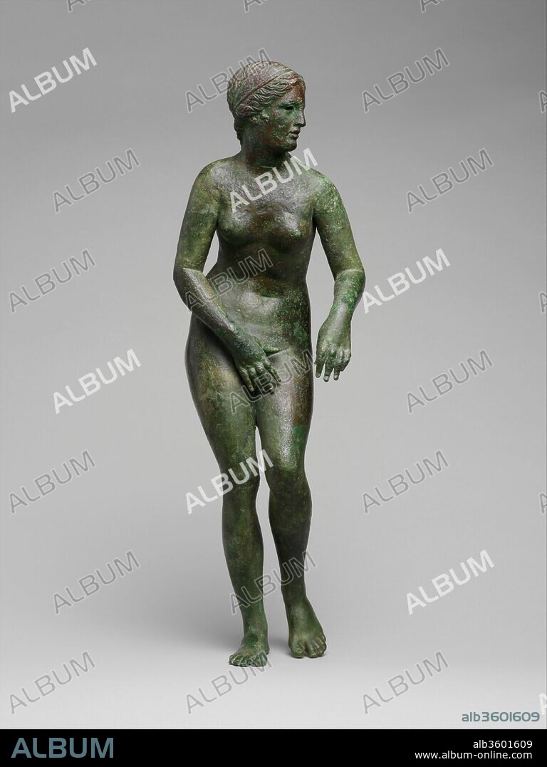 Bronze statuette of Aphrodite. Culture: Greek. Dimensions: H. 20 3/8 in. (51.7 cm). Date: ca. 150-100 B.C..
Variant of the 4th century B.C. Aphrodite of Knidos by Praxiteles
No other sculpture in antiquity enjoyed the renown of Praxiteles' Aphrodite of Knidos. For the Roman author Pliny the Elder (A.D. 23-79), it was not only the finest work by Praxiteles but also the finest statue in the world. Roman coins minted in Knidos that depict the statue provide the general identification of the pose. Aphrodite stands nude, with her weight on her right leg, her head turned to the left, her right hand covering her pubic area, and her left hand holding a fold of drapery that falls onto a hydria (water jar) standing on a pedestal. The statue was erected in a round temple and was meant to be viewed from all sides. The goddess is depicted undressing before (or dressing after) a bath in "heroic nudity" as unconscious and glorious as that of the gods.  
This magnificent large bronze statuette represents only one variation on the Praxitelean original. While originally an over-life-sized work sculpted in Parian marble, the Aphrodite of Knidos was widely imitated and adapted by artists of the Greek and Roman world in many mediums and on many scales.