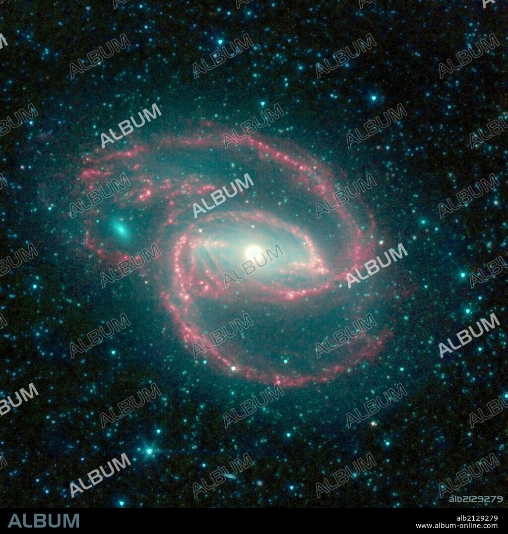 The galaxy, called NGC 1097, is located 50 million light-years away. It is spiral-shaped like our Milky Way, with long, spindly arms of stars. The "eye" at the center of the galaxy is a black hole surrounded by a ring of stars. Spitzer. (Photo by: Universal History Archive/UIG via Getty Images).