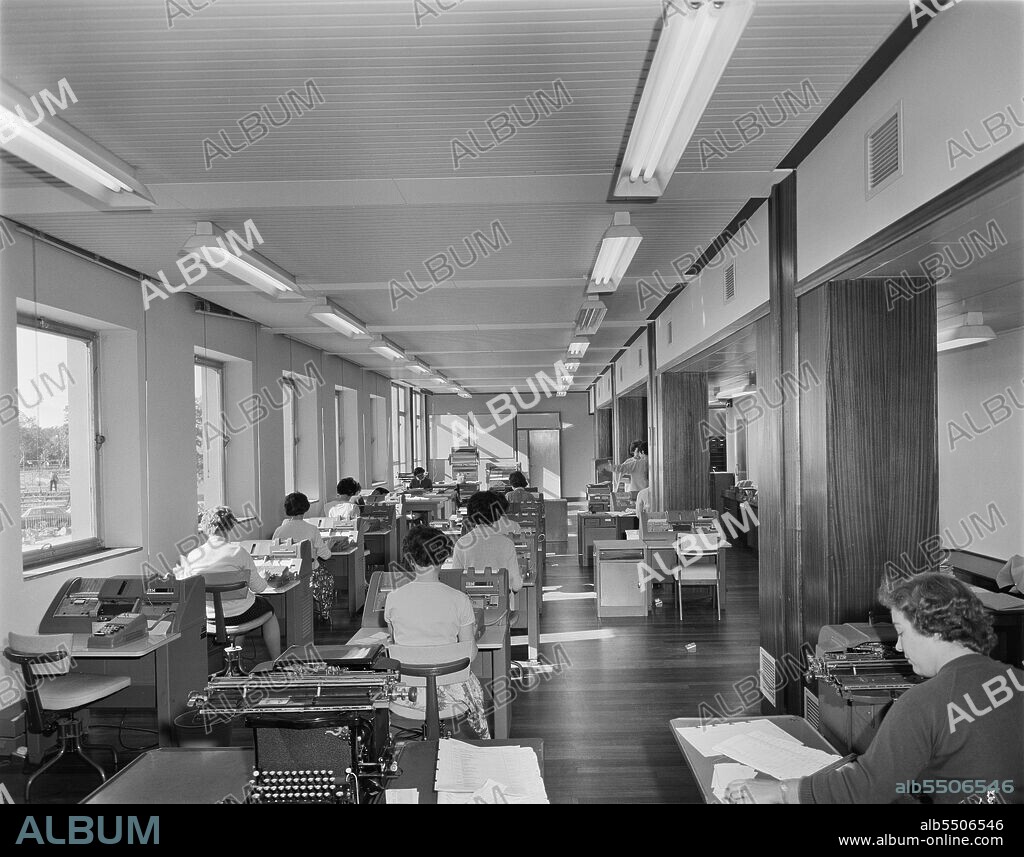 JOHN LAING PLC. County Hall, A6352, Aykley Heads, Durham, County Durham, 24/09/1963. Office workers operating IBM 056 card verifier machines in the new County Offices at Durham. A keypunch was a device used for precisely punching holes into cards at specific locations, determined by the keys struck by a human operator. The verifier operators entered exactly the same data as the keypunch operator, and the machine then checked to see if the punched data matched. The IBM 056 machine was the verifier companion to the IBM 024 Card Punch and IBM 026 Printing Card Punch.