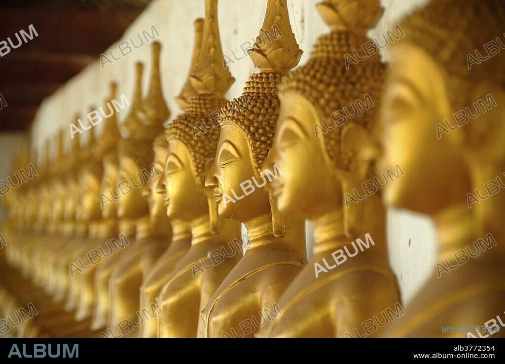 Theravada Buddhism, meditation, row of golden Buddha statues, temple, That Ing Hang Stupa, in Savannakhet, Laos, Southeast Asia, Asia.