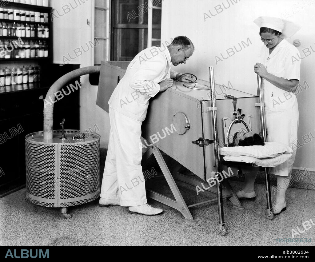 Scots Mission Hospital iron lung. Dr. Torrance, Sister Lee, patient Dow. March, 1940. The first modern and practical respirator nicknamed the "iron lung" was invented by Harvard medical researchers Philip Drinker and Louis Agassiz Shaw in 1927. The inventors used an iron box and two vacuum cleaners to build their prototype respirator. Almost the length of a subcompact car, the iron lung exerted a push-pull motion on the chest. In 1927, the first iron lung was installed at Bellevue hospital in New York City. The first patients of the iron lung were polio sufferers with chest paralysis. Later, John Emerson improved upon Philip Drinker's invention and invented an iron lung that cost half as much to manufacture. By the 1950's and '60's, the invention of portable ventilators made iron lungs obsolete. By 1970, J. H. Emerson Co. ceased manufacturing this apparatus, but many still depend on such mechanical ventilation systems on a daily basis.