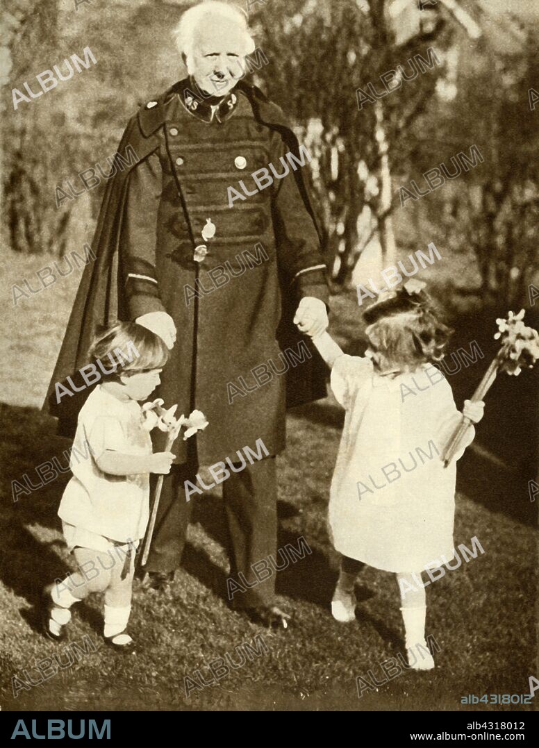 General Bramwell Booth with his two grandchildren, 1929, (1935). William Bramwell Booth (1856-1929) was the son of William Booth, the founder of the Salvation Army, and served as the movement's second general from 1912 until his death. From "The Silver Jubilee Book - The Story of 25 Eventful Years in Pictures". [Odhams Press Ltd., London, 1935].