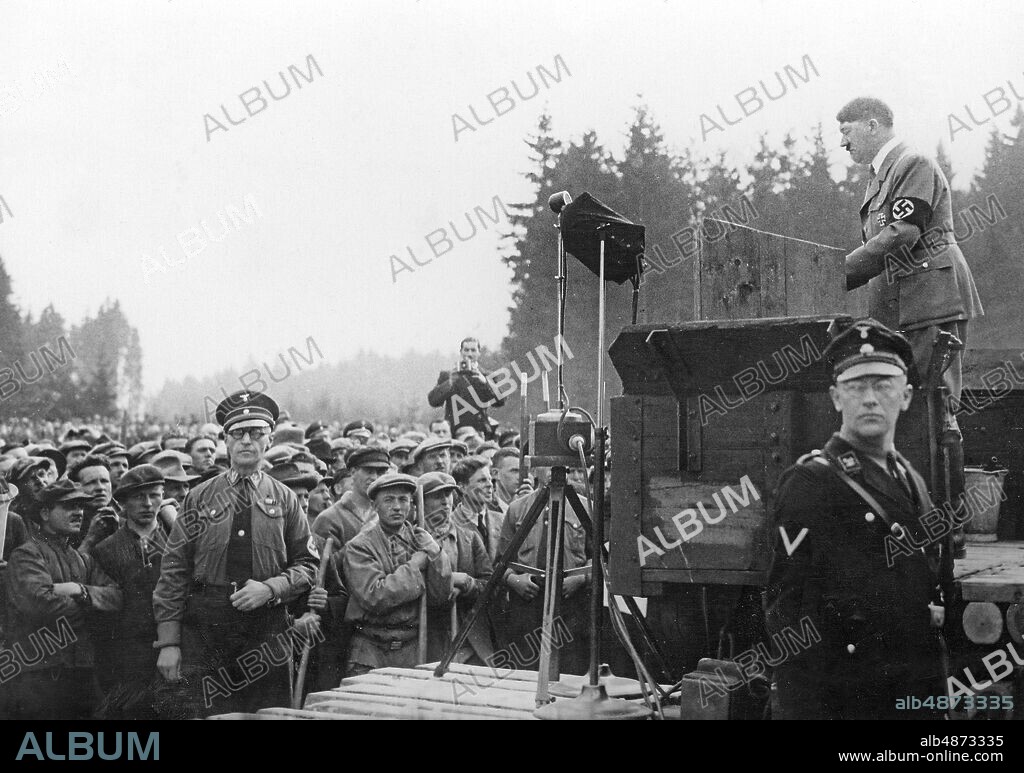 GERMANY UNTERHACHING 1934-03-21. Orig. caption ... THE LEADER OPENS THE SECOND LARGE WORK BATTLE. At the construction site of the Reichsautobahn München - Landesgrenze bei Unterhaching, the leader spoke today to the German nation, which was gathered in the operations at the loudspeaker, and opened the second major battle against unemployment. Chancellor Adolf Hitler in his speech. Photo: Keystone View Company / AB Text & Bilder / SVT / Code: 5600 Folder: Campaign against unemployment in Germany during the 1930s, Hitler era. 2619B Hakkors Talare Autobahn persons: ADOLF HITLER sites: UNTERHACHING; GERMANY.