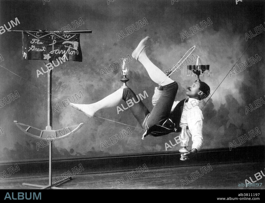 The Great Layton. No photographer credited, dated 1885. Tightrope walking, also called funambulism, is the art of walking along a thin wire or rope. It has a long tradition in various countries and is commonly associated with the circus. Slackwire or slackrope is a type of wire or rope walking where the support is flexible or slack. The tension on the wire or rope is mainly provided by the weight of the performer and their props. The difference in technique required to maintain balance on a slackwire is that the performer moves the wire under their center of mass. The flexibility of the wire or rope allows the performer to achieve this.