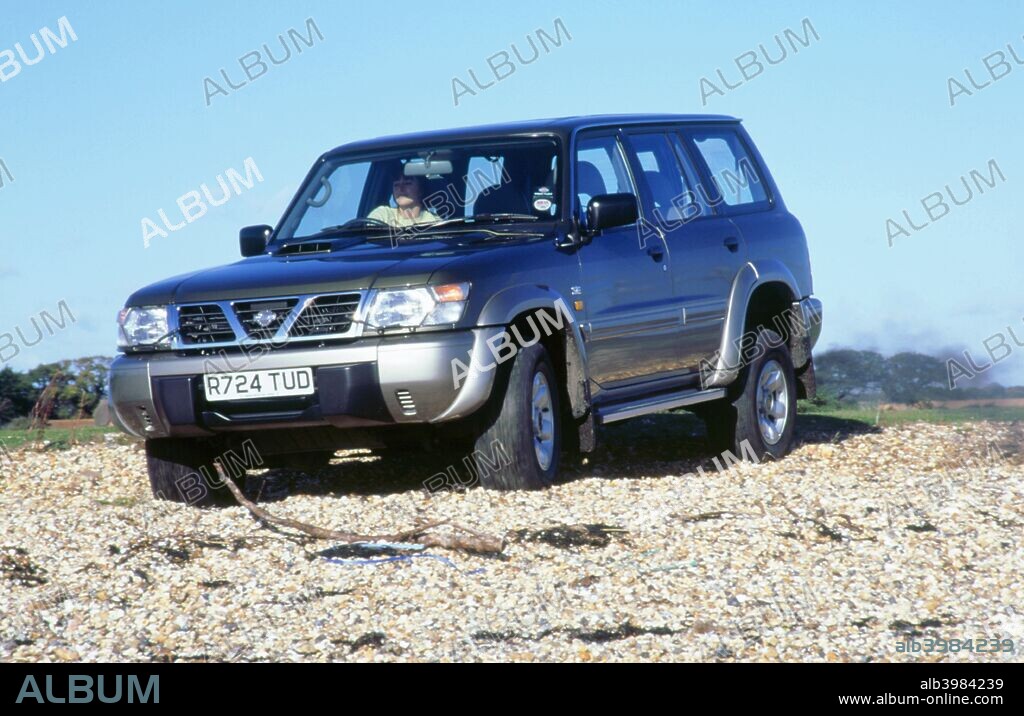 1998 Nissan Patrol GR driving through shingle.