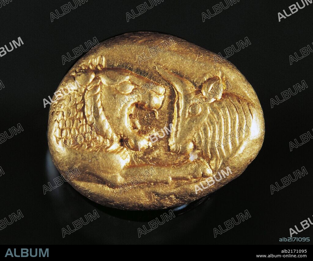 Gold stater of King Croesus depicting a lion facing a bull. Greek coins, 7th century BC.