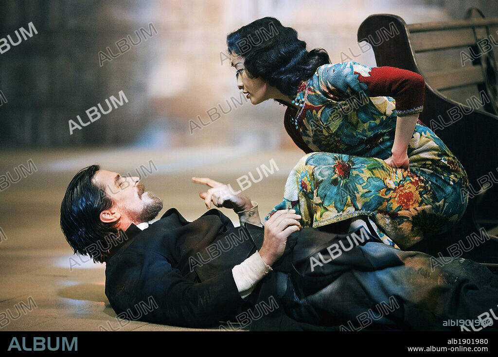 CHRISTIAN BALE and NI NI in THE FLOWERS OF WAR, 2011 (JIN LING SHI SAN CHAI), directed by YIMOU ZHANG. Copyright BEIJING NEW PICTURE FILM CO.