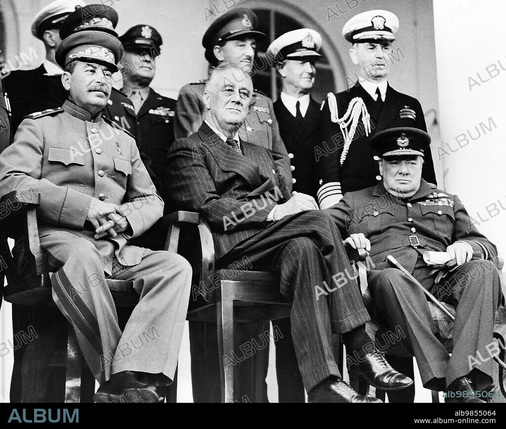 Soviet General Secretary Josef Stalin, U.S. President Franklin Roosevelt, British Prime Minister Winston Churchill, on porch of Russian Embassy during Tehran Conference, Tehran, Iran, U.S. Army Signal Corps, December 1943.
