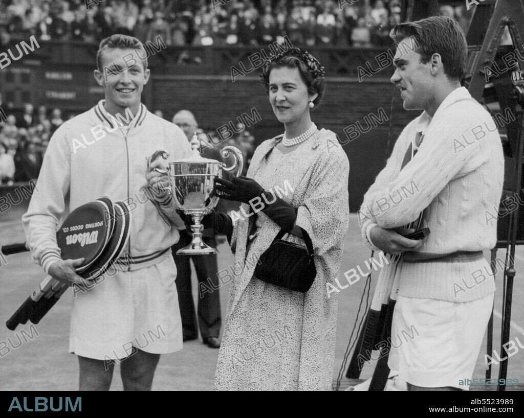 Trabert Receives Wimbledon Cup - America's Tony Trabert receives from the Duchess of Kent, President of the All-England Lawn Tennis Club, the trophy he has just won by beating Denmark's Kurt Nielsen (Watching) in the men's singles final of the Lawn Tennis Championships at Wimbledon, London, this afternoon (Friday). July 01, 1955. (Photo by Reuterphoto).
