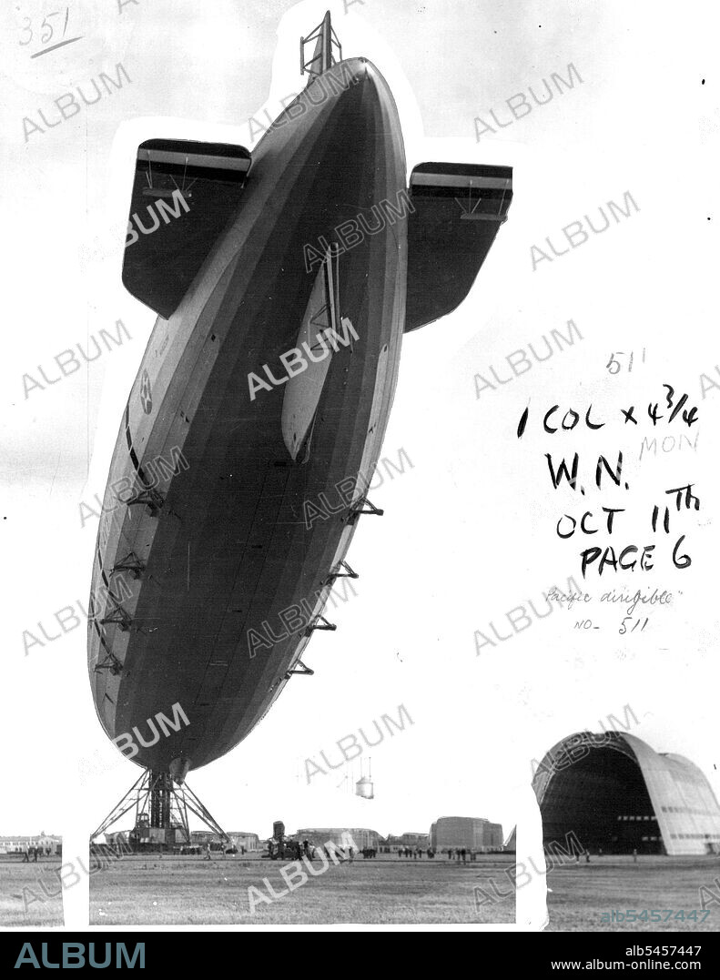 Macon Flies Home To Moffett Field -- After an uneventful trip from Florida, the U.S.S. Macon berthed at its permanent West Coast base, Moffett field, Sunnyvale, Calif., May 18, upon returning from participation in fleet manoeuvers in the Caribbean. The Dirigible is shown at the portable mooring mast with the hangar in background. May 19, 1934. (Photo by Associated Press Photo).
