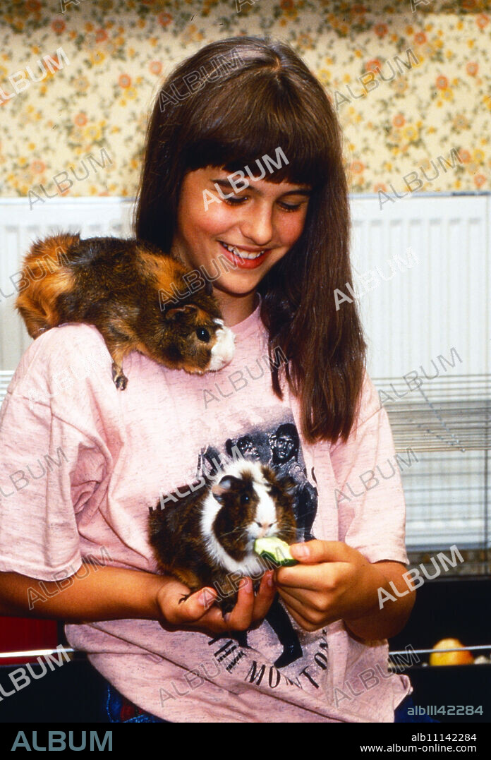 Pamela Großer, young actress and sister of actress Verena, with her guinea pigs at home in Hamburg, Germany around 1990. (original german headline: Pamela Großer).