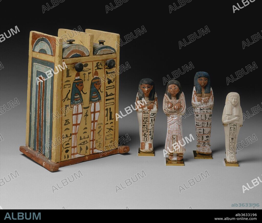 Shabti box and shabtis. Dimensions: Shabti box (86.1.14): H. 28.5 cm (11 1/4 in)
Shabti of Khaibekhnet and Ineferty (86.1.18): H. 16.7 cm (6 9/16 in)
Shabti of Khonsu (86.1.21): H. 17.7 cm (6 15/16 in)
Shabti of Khaibekhnet (67.80): H. 18.6 cm (7 5/16 in)
Shabti of Mesu (86.1.28): H. 15 cm (5 7/8 in). Dynasty: Dynasty 19. Reign: reign of Ramesses II. Date: ca. 1279-1213 B.C..
Essential items of funerary equipment from the New Kingdom on, shabti figures, of which there could be from 1 to over 400 examples in a single tomb, were meant to substitute for the deceased whenever he or she was called upon to perform manual labor in the afterlife. One example here is inscribed with a version of Spell 6 from the Book of Coming Forth by Day (better known as the Book of the Dead): "O, shabti. . . if I be summoned. . .to do any work which has to be done in the realm of the dead. . .you shall act for me on every occasion of making arable the fields, of flooding the banks, or of conveying sand from east to west: 'Here I am,' you will say." (after Faulkner, The Ancient Egyptian Book of the Dead). The others bear the name of the deceased with whom they were associated.
The wooden shabti box is inscribed for Paramnekhu, a servant in the Place of Truth (royal artisan) who was a son or grandson of Sennedjem in whose tomb (TT 1) the box was found. The shabti figures, from left to right, are inscribed for Sennedjem's wife Iineferty and her eldest son, Khabekhnet (86.1.18); for another son, Khonsu (86.1.21); for Khabekhnet alone (67.80); and for a female relative named Mose (86.1.28). Although Khabekhnet and Khonsu had a separate tomb complex (TT 2) near that of their father, they are depicted with their siblings in the decoration of Sennedjem's burial chamber, and objects inscribed with their names (including Khonsu's coffins and mummy) were buried in the family tomb. Other objects in the collection that were discovered in Sennedjem's tomb are numbered 86.1.1-86.1.29.