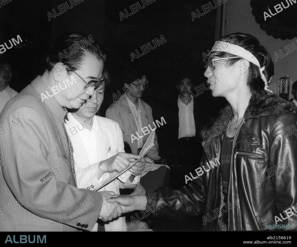 Chinese premier Li Peng (left) shakes hands with Wang Dan, representative of Beijing University pro-democracy hunger strikers. May 1989. Beijing, China. (Photo by: Sovfoto/UIG via Getty Images).