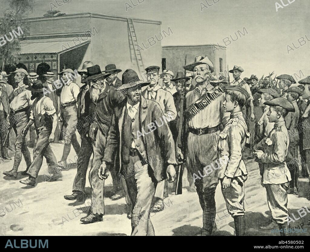 HENRY MARRIOTT PAGET. 'The Last Attack on Mafeking: B.S.A. Police Escorting Boer Prisoners to the Gaol', 1901. The siege of Mafeking was lifted on 17 May 1900 - British South Africa Police escort Boers to jail. From "South Africa and the Transvaal War, Vol. V", by Louis Creswicke. [T. C. & E. C. Jack, Edinburgh, 1901].