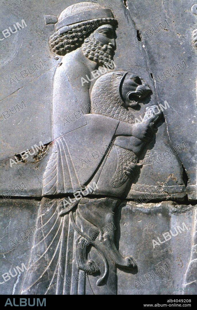 Relief of a man holding a lion cub, Persepolis, Iran. Persepolis was built as Persia's new capital city during the reign of Darius I (522-485 BC) and his son Xerxes I (485-465 BC). The city was sacked by Alexander the Great in 330 BC.