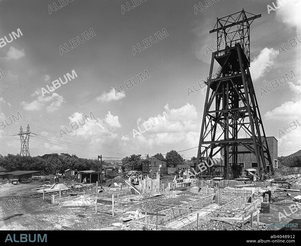 The new headgear at Kilnhurst Colliery, South Yorkshire, 1957. The new headgear under construction at Kilnhurst Colliery near Rotherham. The original pit was sunk in 1859 and until 1924 it was operated by J&J Charlsworth and Co. The pit was sold along with its associated brickworks to Stuart and Lloyd Ltd. The brickworks closed in 1975 and the last coal was mined in 1989. The site was redeveloped to accomodate industrial units.