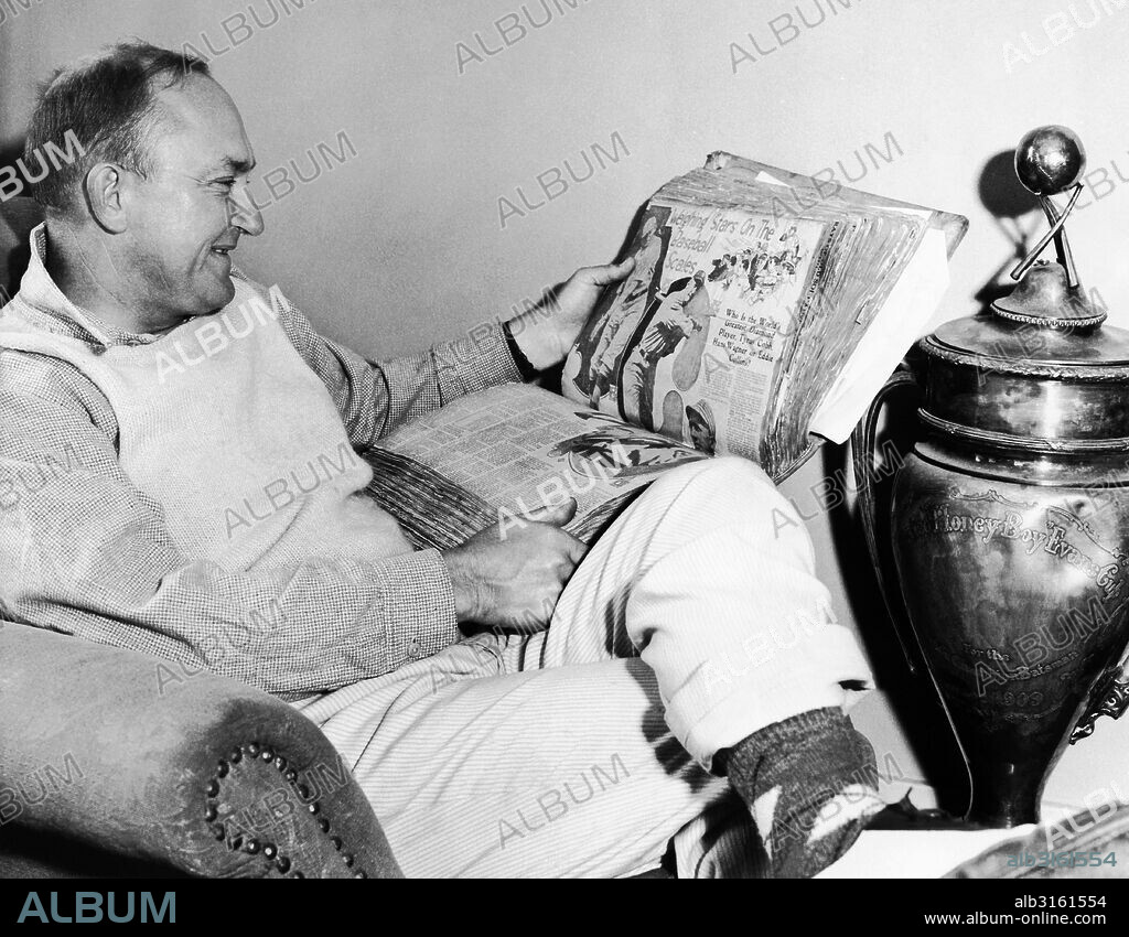 Atherton, California: July 11, 1936 Baseball star Ty Cobb looks at a scrapbook of his playing days.