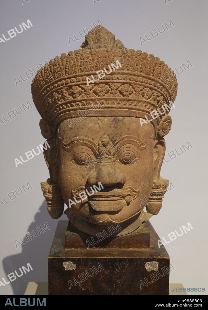 Cambodia: A 10th century sandstone head of a Yaksha (guardian deity) originally from Banteay Srei temple near Siem Reap, now in the National Museum of Cambodia, Phnom Penh. The National Museum, housed in a red pavilion built in 1918, holds a collection of Khmer art including some of the finest pieces in existence. Exhibits include a 6th century statue of Vishnu, a 9th century statue of Shiva, and the famous sculpted head of Jayavarman VII in meditative pose. Particularly impressive is a damaged bust of a reclining Vishnu which was once part of a massive bronze statue found at the Western Mebon Temple in Angkor.