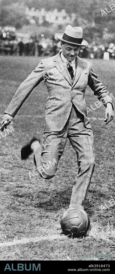 The Prince of Wales kicking off the Spurs versus Fulham football match, 1921. The future King Edward VIII on the pitch. Illustration from George V and Edward VIII, A Royal Souvenir, by FGH Salusbury, a souvenir book published as Edward VIII was crowned following the death of his father, George V, (Daily Express Publication, London, 1936).