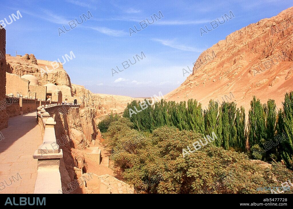 The Bezeklik Thousand Buddha Caves (Bozikeli Qian Fo Dong) are complex of Buddhist cave grottos dating from the 5th to the 9th centuries. There are 77 rock-cut caves at the site. Some ceilings are painted with a large Buddha surrounded by other figures, including Indians, Persians and Europeans. The quality of the murals vary with some being artistically naive while others are masterpieces of religious art. The Turpan Oasis was a strategically significant centre on Xinjiang’s Northern Silk Route, site of the ancient cities of Yarkhoto (Jiaohe) and Karakhoja (Gaochang). Chinese armies first entered Turpan in the 2nd century BC, during the reign of Han Emperor Wu Di (141-87) when the oasis was a centre of Indo-European Tocharian culture. Turpan retained a distinctly Buddhist character until the time of the Chagatai Khanate in the 13th century, when Islam gradually became the dominant religion.