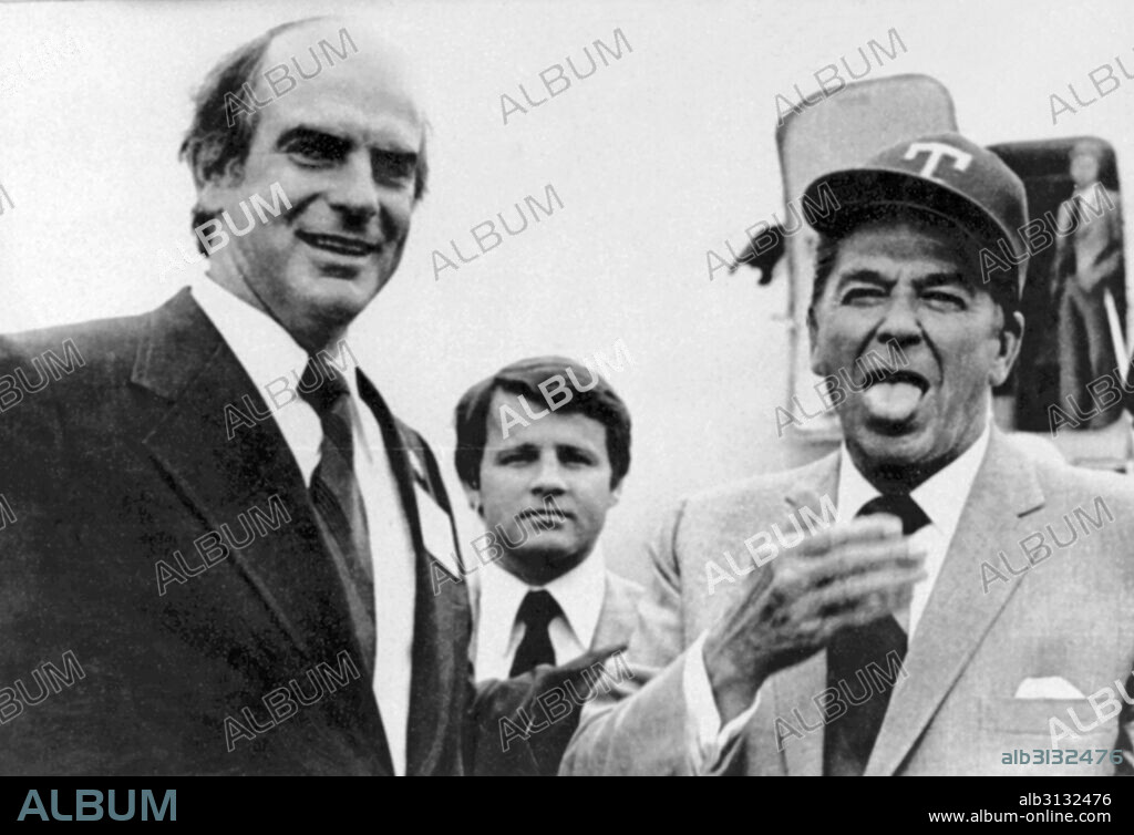 Dallas, Texas:  April 30, 1976 Texas Rangers pitcher Gaylord Perry presents Republican presidential candidate Ronald Reagan with a Texas Ranger hat and in turn, Reagan proceeds to mimic Perry's famous spitball pitch by licking his hand.