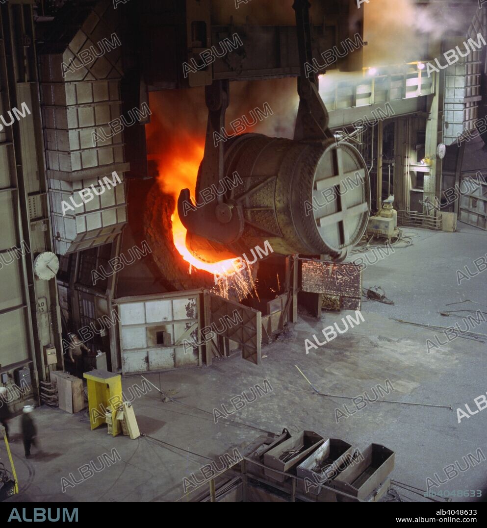 A steel pour at Newton Chambers, Chapeltown, Sheffield, South Yorkshire, 1971. George Newton and Thomas Chambers entered into a partnership in 1789 that would result in the founding of one of England's largest industrial companies of that era, Newton, Chambers & Co. During the Second World War the company built the Churchill Tank and the company also owned other well known brands such as Redfyre and Izal.