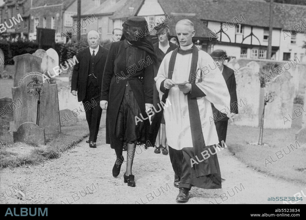 The Duchess of Kent arriving in the little village church in Iver, Bucks, near which she and the late Duke had their country home, to attend a memorial service to her husband. She is with the Vicar, the Rev. Digby Creighton. August 31, 1942.