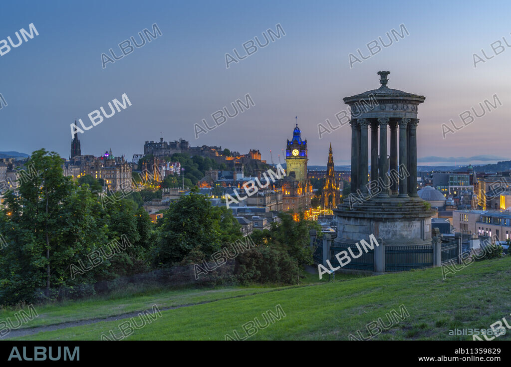 View of Edinburgh Castle, Balmoral Hotel and Dugald Stewart monument from Calton Hill at dusk, UNESCO World Heritage Site, Edinburgh, Lothian, Scotland, United Kingdom, Europe.