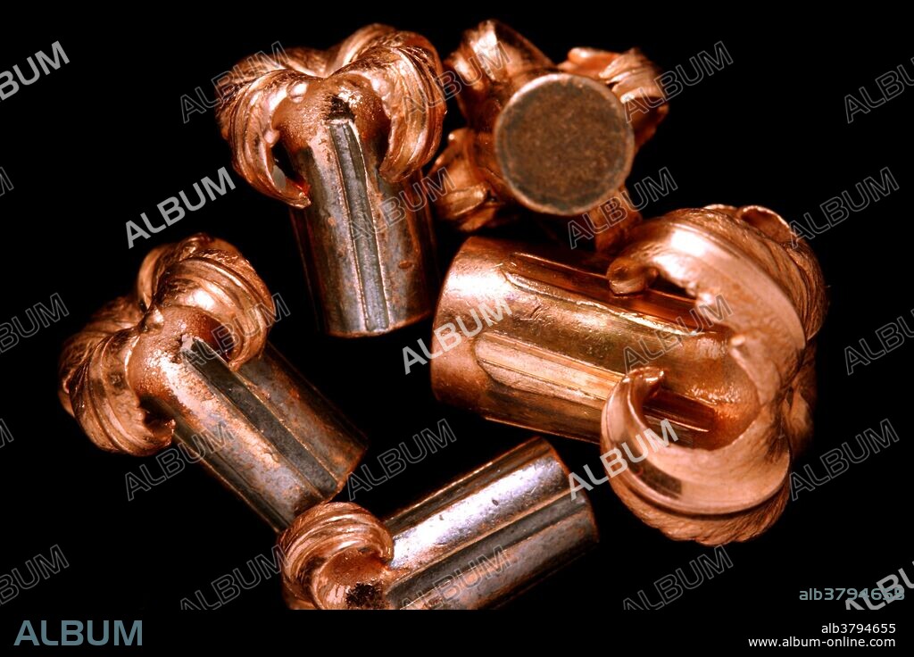 A collection of hollow point bullets is photographed after being fired from a rifle into a block of ballistic gelatin. These bullets are designed to peel open on impact to obtain the largest amount of damage to the target. These bullets are designed for hunting animals.