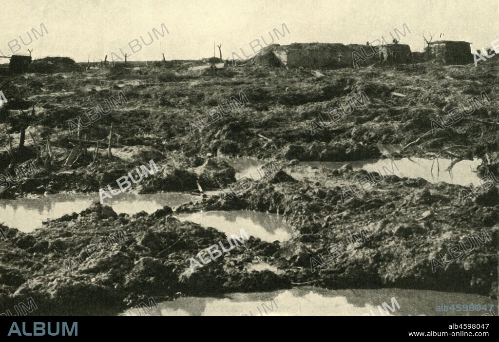'The Way to Passchendaele', First World War, 1917, (c1920). '...typical view across the battle-field over which our troops had to advance in the autumn of 1917'. Heavy rain and mud made conditions extremely difficult during the Third Battle of Ypres, also known as the Battle of Passchendaele, which took place on the Belgian Western Front from July to November 1917. It was fought between the British, Belgian and French armies against the Germans, and resulted in the deaths of hundreds of thousands of men. From "The Great World War: A History", Volume VII, edited by Frank A Mumby. [The Gresham Publishing Company Ltd, London, c1920].