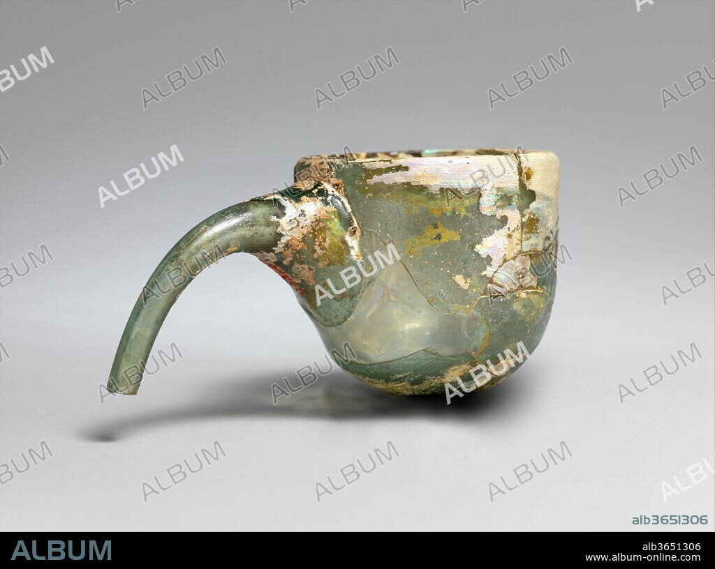 Physician's Cupping Glass or Alembic. Dimensions: H. 1 15/16 in. (5 cm)
L. 3 7/8 in. (9.9 cm). Date: 9th-11th century.
The suggested identifications for this object, of which numerous examples have been found at Nishapur and other excavation sites, include cupping glass, alembic, baby feeder, and breast reliever. The most recent proposal splits the objects into two types: those with straight spouts and those with curved spouts. The straight-spouted vessels may have served as alembics, which are used in distilling liquids; those with curved spouts may have served as cupping glasses, which were placed on the skin in medieval medical treatments. Only one thing is clear: after the twelfth century, the production of both types ceased.