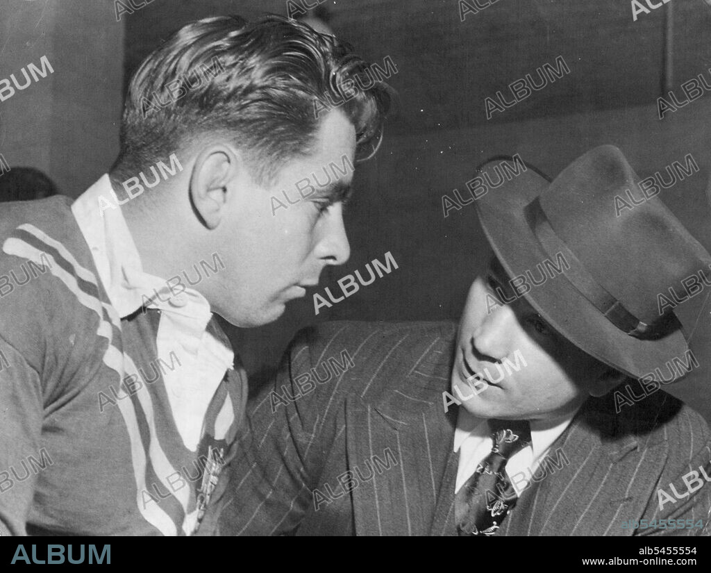 Australian League coach Vic Hey "briefed" Queensland forward Duncan Hall before the start of today's Test against France at SCG. June 11, 1951.