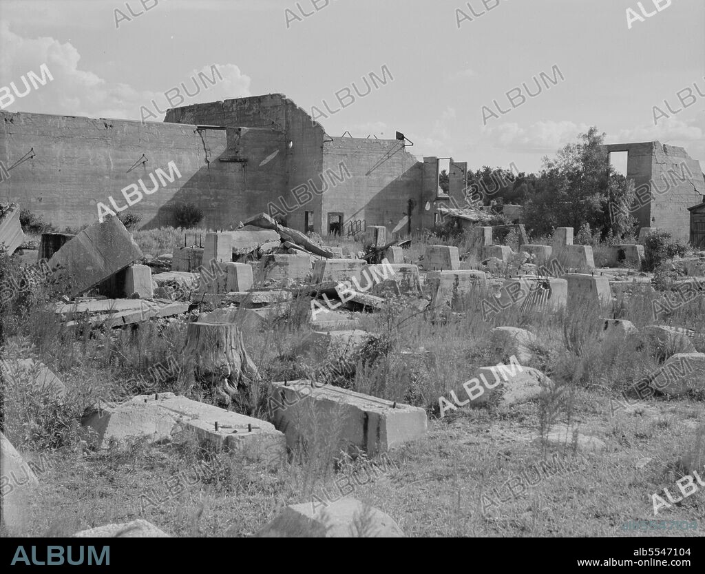 DOROTHEA LANGE. Foundations of lumber sheds in Fullerton, Louisiana, an abandoned lumber town.