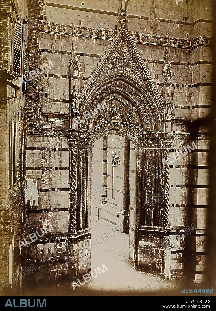 Paolo Lombardi, side portal at the Cathedral of Siena, albumin paper, black and white positive process, sheet size: height: 34.10 cm; width: 24.80 cm, stamp engraving: recto and left: blind stamp: P. Lombardi, Fotografo, Siena, inscribed: recto on the cardboard: Dom Siena, architectural photography, facade (church building), portal (church building), architectural details, sculpture, sculpture art, hist. building, locality, street.